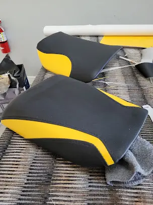 Set of motorcycle seats recoverd in black and yellow vinyl