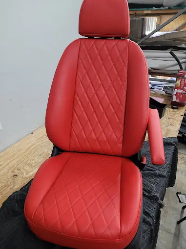 Mercedes front seat reupholstered with red sports vinyl